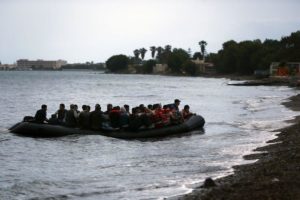 A dinghy overcrowded with Afghan immigrants lands at a beach on the Greek island of Kos